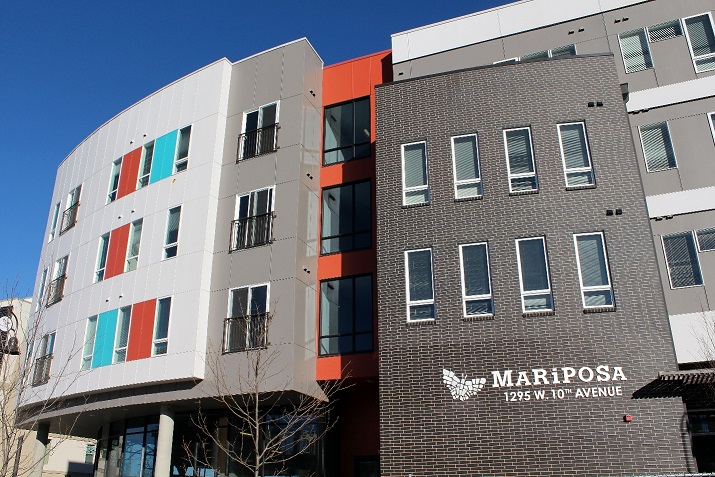 Exterior image of a multi-story, mixed-use building that incorporates several different materials and colors into the façade and bears the Mariposa name and butterfly logo.