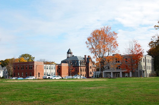 Photograph of two rehabilitated historic buildings (shown middle and left) and a new building (shown on the right).