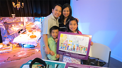 Samantha Tan, surrounded by her family, holds her poster which was the winning entry in the Fair Housing Council of Oregon sponsored poster contest.