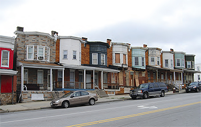 A block of neat two-story residences redeveloped in a distressed neighborhood.