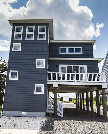 A house is elevated on stilts to protect from flood damage in West Creek, New Jersey.