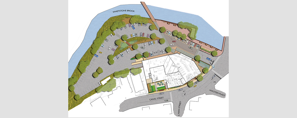 Rendered site plan of the development between a commercial corridor and a river, showing a mixed-use building, parking lot, landscaped seating area, walking path, and greenspace.