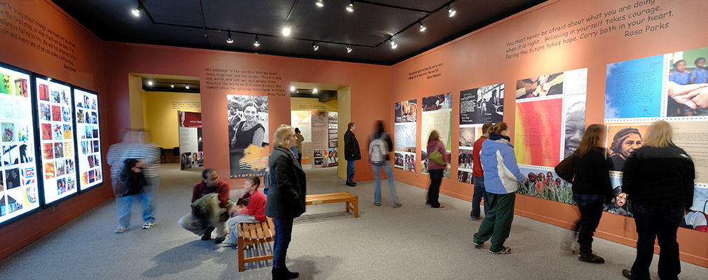 Interior photograph of people looking at an exhibition.