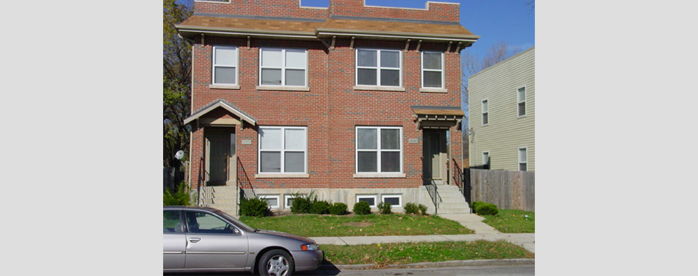 Photograph of a two-story duplex with a brick façade.