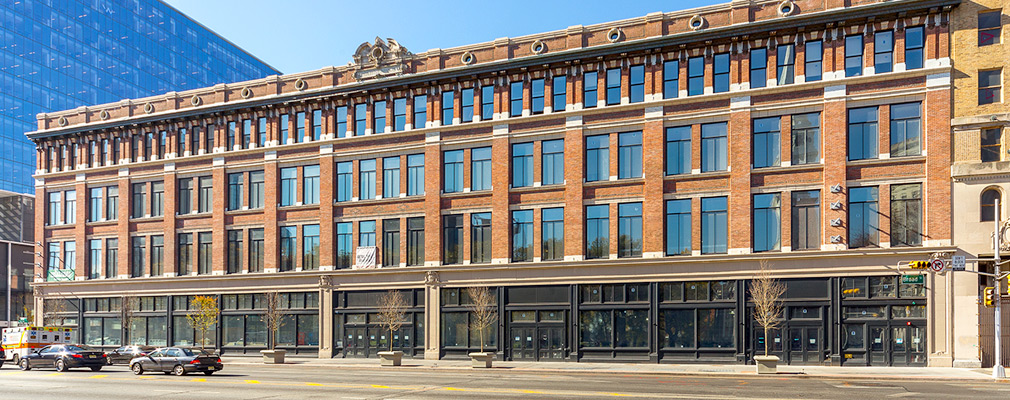 Photograph of the front façade of a four-story, Renaissance revival commercial building.