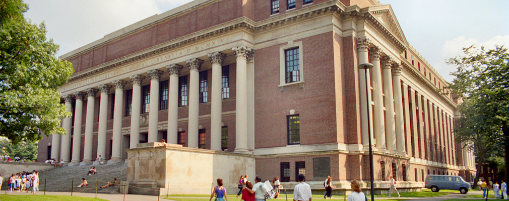 Photograph of two façades of Harvard University’s Widener Library, a four-story brick building with a colonnade marking the entrance.