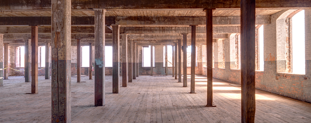 Photograph of the interior of a gutted mill building.