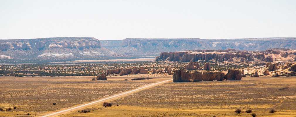 Panoramic photograph of the landscape of the Acoma Pueblo, with Sky City on the top of the mesa in the middle ground.