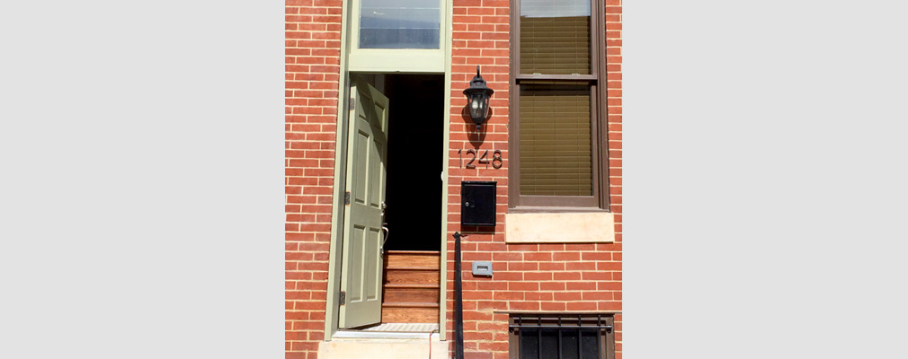Photograph of the entrance to a renovated brick rowhouse.  