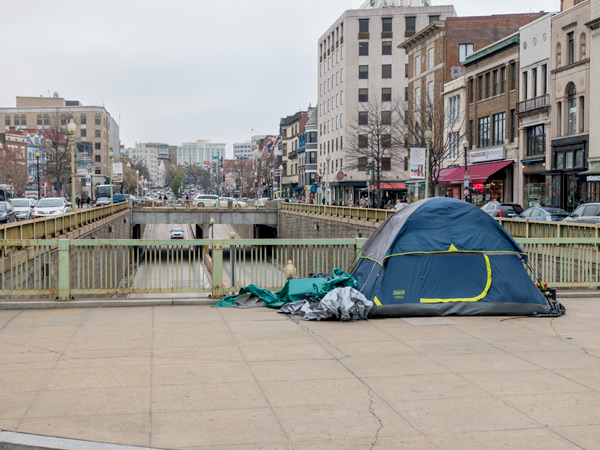 Photograph of a tent on a sidewalk in the Dupont Circle neighborhood of Washington, DC.