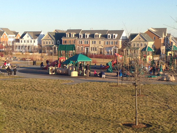 Photograph of townhomes in Montgomery County, Maryland with a playground in the foreground.