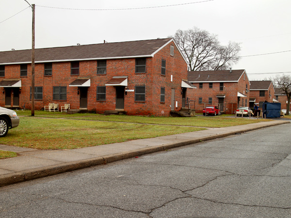 Photograph of a row of brick barracks-style two-story multifamily housing