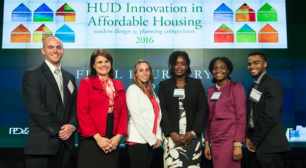 The University of Maryland at College Park team and HUD Deputy Secretary Nani Coloretti stand in front of the 2016 Innovation in Affordable Housing background.