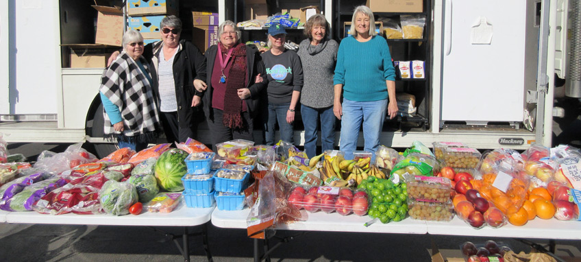 Rogue River Estates resident volunteers are shown in front of the weekly ACCESS Mobile Food Market truck.