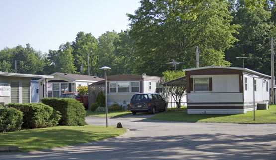 Photograph of four mobile homes sited in a mobile home park.