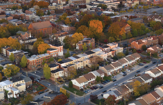 Aerial view of a residential area of Wilmington, Delaware with commercial buildings in the background.