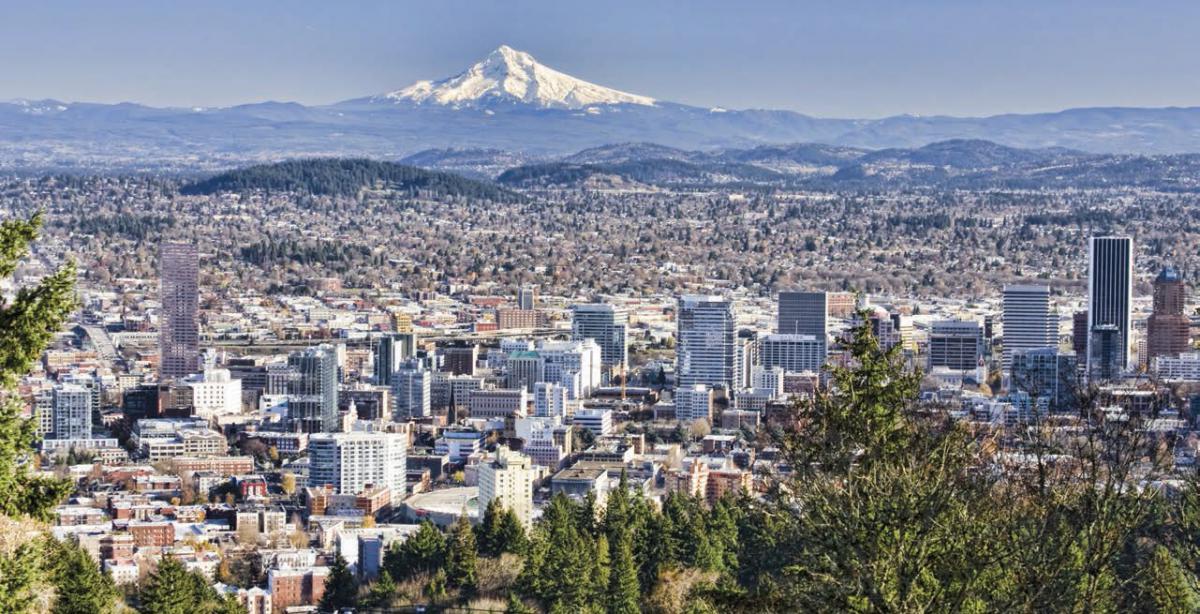 An aerial view of the city of Portland with Mount Hood in the background
