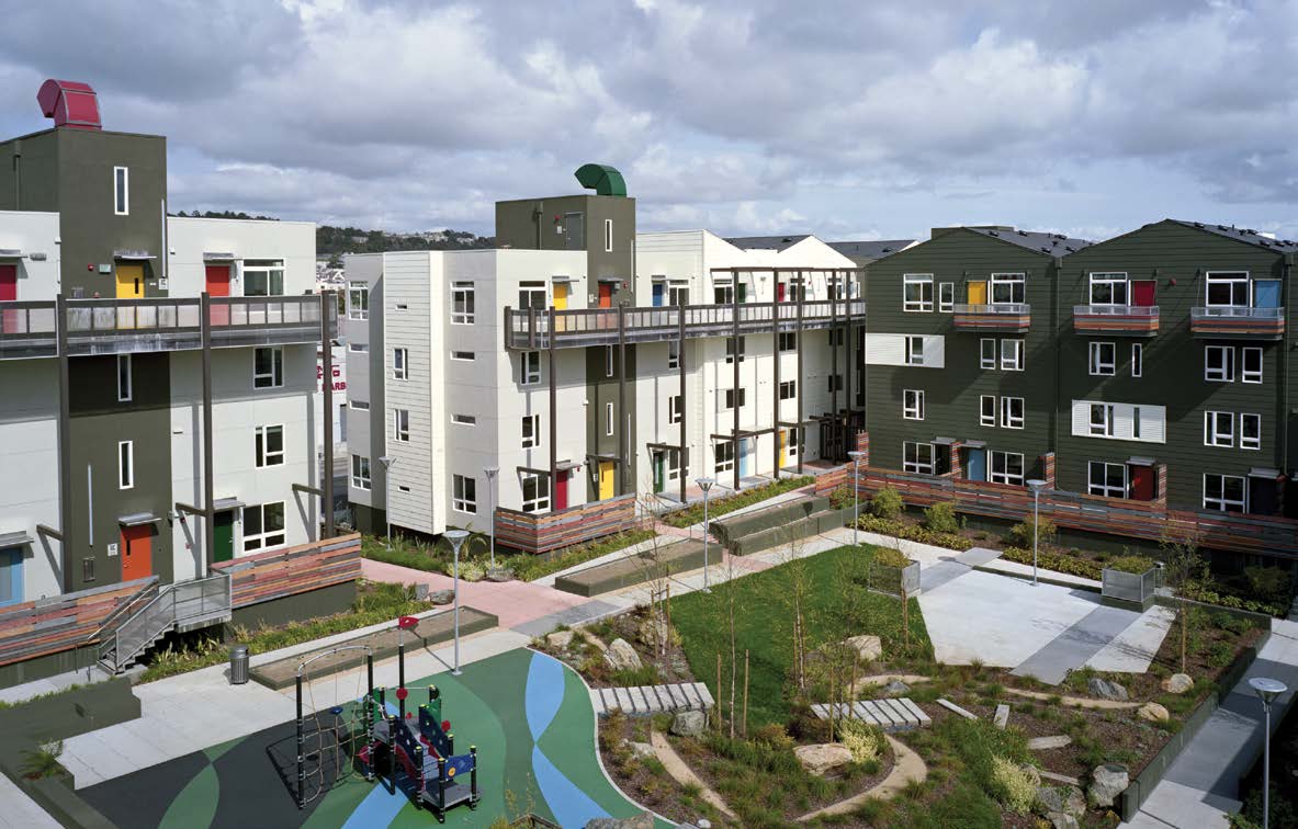 Apartment buildings situated around a play area and community garden.