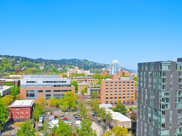 Photo of buildings in Portland, Oregon under a blue sky.