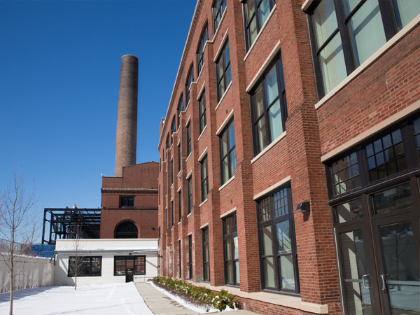 Exterior image of a former brick industrial building converted into loft apartments. 