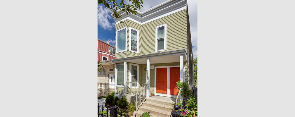 Photograph of the front façade of a two-story, two-unit building. Photograph of the front façade of a two-story, two-unit building.