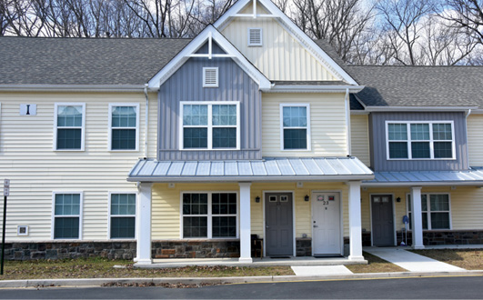 Front view of a two-story multifamily building. Front view of a two-story multifamily building.