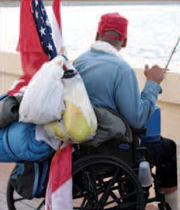 A picture of a disabled homeless veteran in a wheelchair.