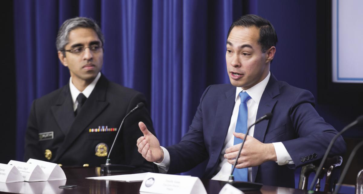 U.S. Surgeon General Vivek Murthy seated next to HUD Secretary Castro who is speaking. Image