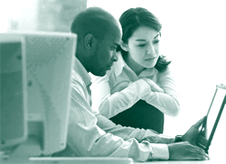 A picture of two researchers working at a computer.