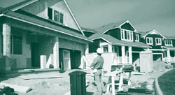 A picture of a worker in a site-built housing development under construction.