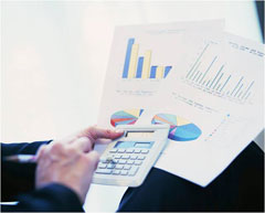 A person prepares data and charts.