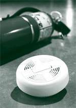 A picture of a fire extinguisher and a smoke alarm.
