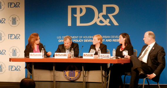 Moderator Yolanda Chavez of HUD, Alan Mallach of the Brookings Institution, Terry Schwarz of Kent State University's Cleveland Urban Design Collaborative, Sara Toering of the Center for Community Progress, and U.S. Congressman Dan Kildee sit at a table in front of a PD&R banner, speaking to a seated crowd visible in the foreground.