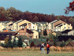 Image of two Residents walking infront of a development.