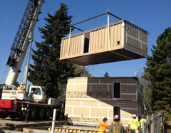 Photograph of the modules that were set on their foundations with a crane and stacked in three stories.