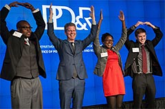 After winning the inaugural IAH competition with their design to house homeless veterans, Ohio State University team members posed on stage with HUD Secretary Shaun Donovan. Photo courtesy of HUD photographer. 