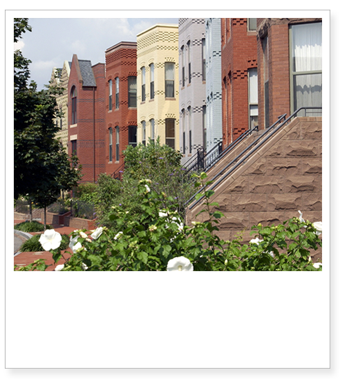 Image of a row of townhomes with varied facades.