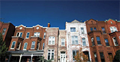 Row houses pictured from street level.