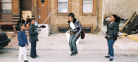 Children jumping rope in front of residential building.