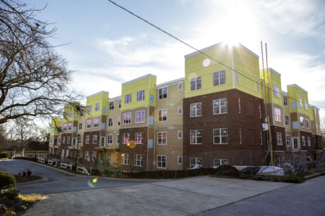 A photograph shows a picture of the Reynoldstown Senior Residences during the day.