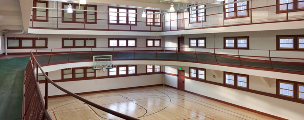 Photograph taken from the elevated track showing the basketball court below and a walkway above.
