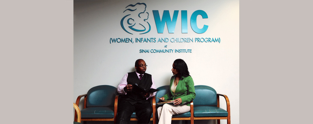 Photograph of two people talking at the Sinai Community Institute’s WIC office.