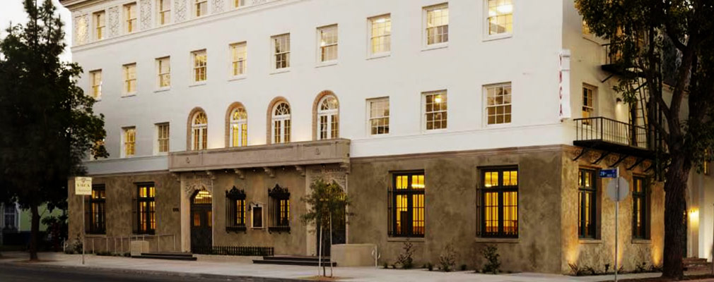 Photograph of the front façade of a four-story masonry building.