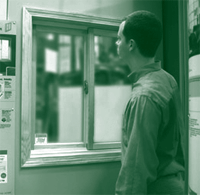 A picture of a man selecting a storm window eligible for federal energy tax credits.