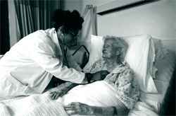 A picture of an elderly woman being treated at an acute care hospital, where patients receive typical hospital-based services under Section 242 mortgage insurance program.