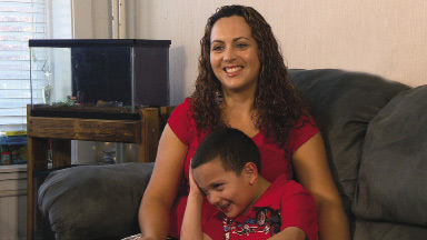  A mother and son sitting in their home that has just been asthma-proofed.