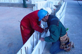 Workers constructing the reinforced ICF walls.