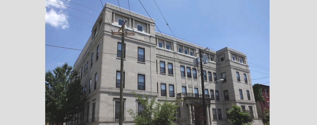 Photograph of the front façade of a four-story building, the Drueding Center.