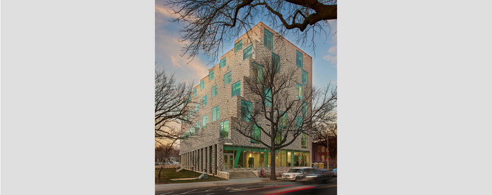 Stepped residential building with large windows.