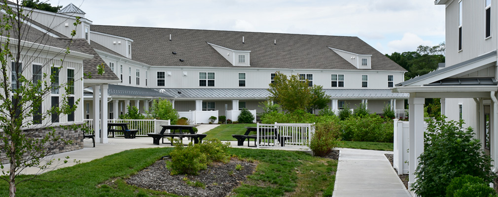 A walking path connecting several two-story apartment buildings.